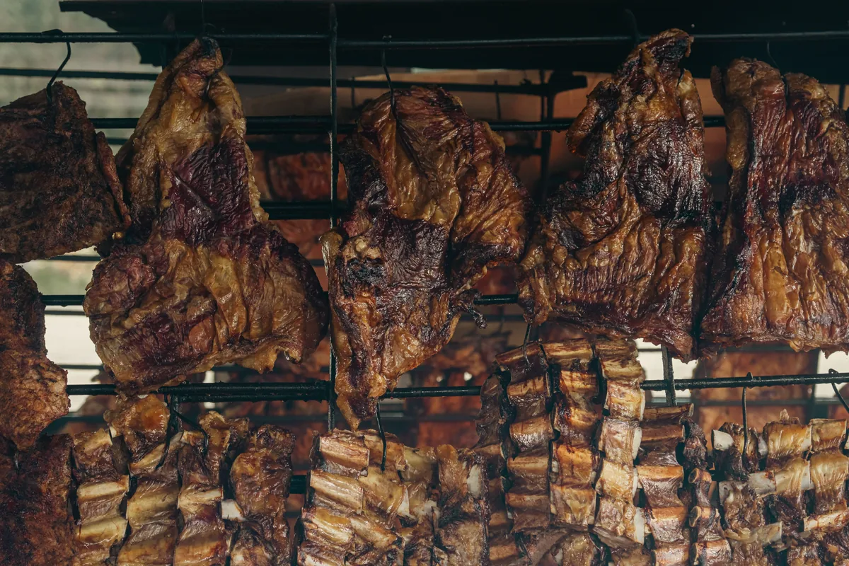 Cuts of beef and ribs roasting on a traditional Argentine parrilla